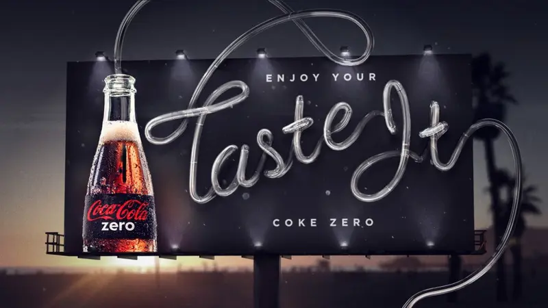 Coke Zero billboard at dusk: a bottle beside neon-style script reading 'Enjoy your Taste It'
