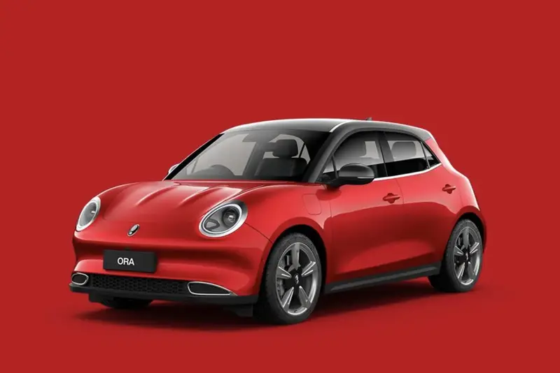 Red GWM ORA electric hatchback on a red background