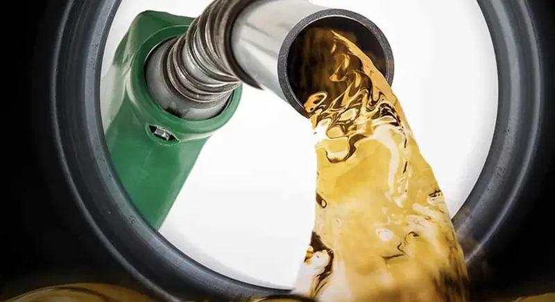 Fuel pouring from a petrol pump nozzle, a metaphor for branding as the fuel of a business
